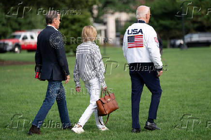 U.S. President Joe Biden wears the team USA Olympics jacket as he departs from the South Lawn of the White House