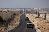 Israeli military vehicles drive through the Philadelphi Corridor area in southern Gaza