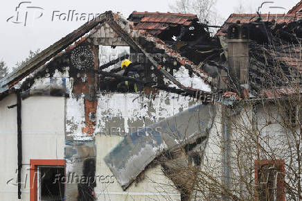 A firefighter works at a damaged nursing home that caught fire, outside Belgrade