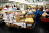 FILE PHOTO: United States Postal Service clerks sort mail at the USPS Lincoln Park Carriers Annex in Chicago