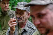 Ukrainian serviceman smokes at a position in a front line in Donetsk region