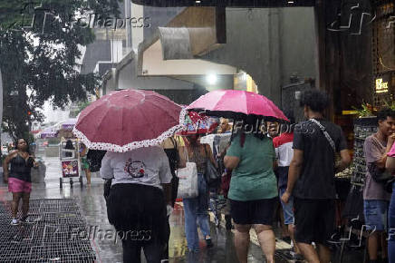 Pedestres enfrentam chuva na Avenida Paulsita, em So Paulo (SP)