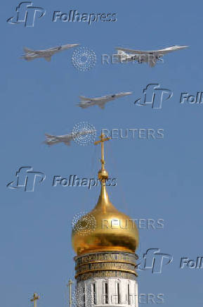 FILE PHOTO: A Tupolev Tu-160 and Tu-22M3 military aircraft fly in formation during a rehearsal for the Victory Day parade in Moscow