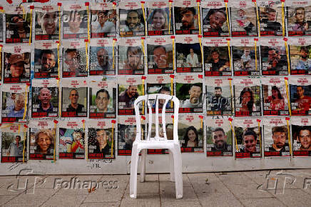 FILE PHOTO: Chair is left in front of posters with pictures of hostages who were kidnapped during the deadly October 7 attack on Israel by Hamas, in Tel Aviv