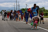 Migrants walk in a caravan in an attempt to reach the U.S. border, in Huixtla