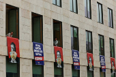 Far-right political party Chega expose banners on the facade of the Portuguese parliament against the wage reinstatement for politicians after the cuts imposed by the Troika, during the debate and vote of the 2025 budget bill on final reading, in Lisbon