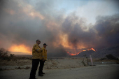 Firefighters and aircraft battle the Hughes Fire near Santa Clarita