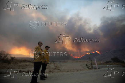 Firefighters and aircraft battle the Hughes Fire near Santa Clarita