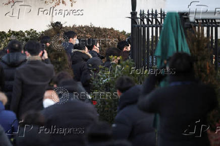 Members of the Corruption Investigation Office for High-ranking Officials gather in front of the impeached South Korean President Yoon Suk Yeol's official residence