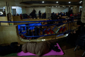 People take shelter inside a metro station during a Russian military strike in Kyiv