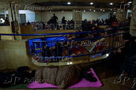 People take shelter inside a metro station during a Russian military strike in Kyiv