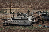 Israeli army soldiers and tanks gather in northern Israel