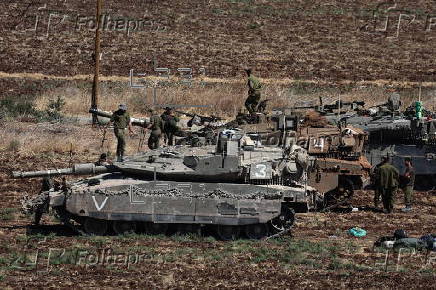 Israeli army soldiers and tanks gather in northern Israel