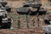 Israeli army soldiers and tanks gather in northern Israel