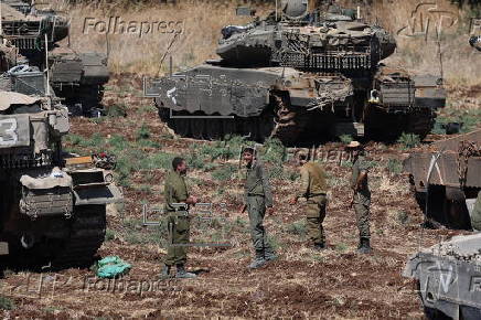 Israeli army soldiers and tanks gather in northern Israel