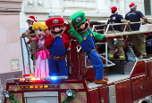 Firefighters dressed as Super Mario characters greet people during Christmas season celebrations in Valparaiso