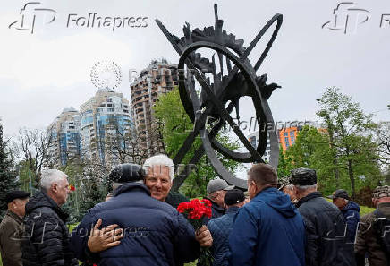People attend a ceremony marking the anniversary of the Chornobyl nuclear disaster in Kyiv