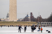 People skate on the ice-covered Lincoln Memorial Reflecting Pool on the National Mall, in Washington