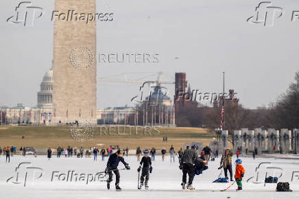 People skate on the ice-covered Lincoln Memorial Reflecting Pool on the National Mall, in Washington