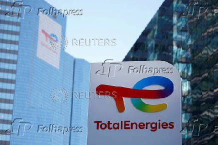 FILE PHOTO: A TotalEnergies sign at an electric vehicle fuelling station near Paris