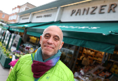 Joseph, owner of Panzer's, poses outside delicatessen in London