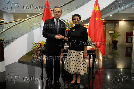 Chinese Foreign Minister Wang Yi and Indonesian Foreign Minister Retno Marsudi shake hands during their meeting in Jakarta