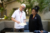 Michael Brasier, a Maricopa County elections worker and Monica Murray Supervisor for the Special Election Board speak to the press