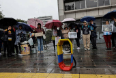 People gather to protest against the forced disappearance of four minors, in Quito