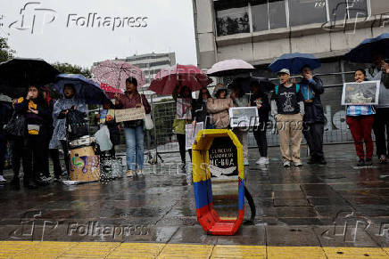 People gather to protest against the forced disappearance of four minors, in Quito