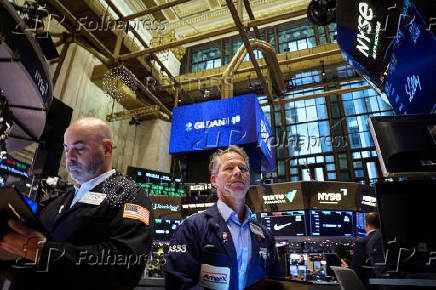 Traders work on the floor of the NYSE in New York