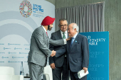 WBG President Ajay Banga shakes hands with Japanese Finance Minister Shun'ichi Suzuki during IMF meetings
