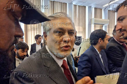 FILE PHOTO: Ishaq Dar leaves after a press briefing in Islamabad