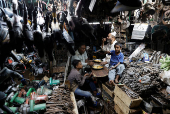 Muslims eat their Iftar (breaking of fast) meal at a shop that sells industrial tools during the fasting month of Ramadan in the old quarters of Delhi