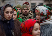 People dressed in traditional Ukrainian costumes attend a Christmas celebration in Lviv