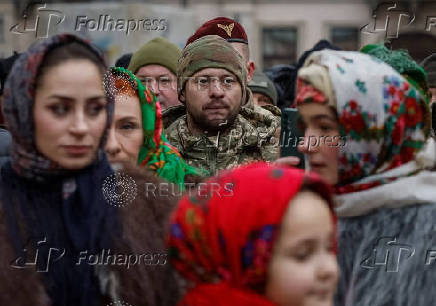 People dressed in traditional Ukrainian costumes attend a Christmas celebration in Lviv