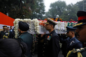 Military officers carry the coffin with the mortal remains of India's former PM Singh at the Congress party?s headquarters in New Delhi