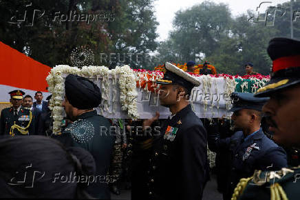 Military officers carry the coffin with the mortal remains of India's former PM Singh at the Congress party?s headquarters in New Delhi