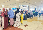 People queue at the check-in counter after a rainstorm hits Dubai, causing delays at the Dubai International Airport