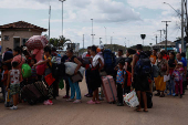 Venezuelans queue to enter a shelter after leaving Venezuela, in Pacaraima