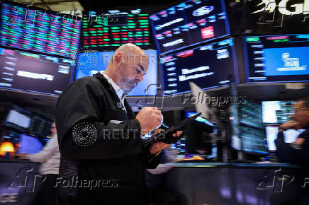 Traders work on the floor of the NYSE in New York