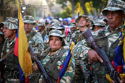 Members of the Bolivarian Militia and supporters of President Nicolas Maduro march to plead allegiance