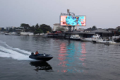 A man sails a boat on a lagoon near the Lekki-Ikoyi Link Bridge in Lagos