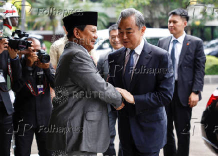 Indonesia?s Defence Minister and President-elect Prabowo Subianto greets Chinese foreign minister Wang Yi during their meeting in Jakar