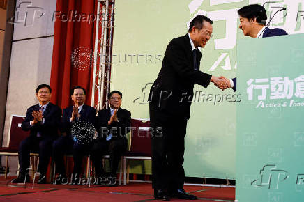 Taiwan President-elect Lai Ching-te and Incoming Defence Minister Wellington Koo, shake hands during a press conference, in Taipei