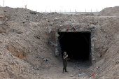 An Israeli soldier stands at the entrance to a tunnel leading to Egypt, in the Philadelphi Corridor area in southern Gaza