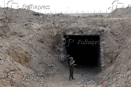 An Israeli soldier stands at the entrance to a tunnel leading to Egypt, in the Philadelphi Corridor area in southern Gaza