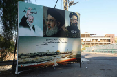 A poster depicting late Hamas leader Ismail Haniyeh, Hezbollah leader Sayyed Hassan Nasrallah and Hezbollah top commander Fuad Shukr is seen in Wadi El Zayni