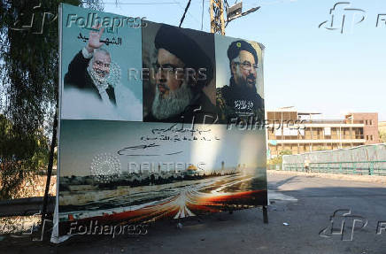 A poster depicting late Hamas leader Ismail Haniyeh, Hezbollah leader Sayyed Hassan Nasrallah and Hezbollah top commander Fuad Shukr is seen in Wadi El Zayni