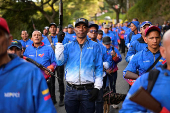 Members of the Bolivarian Militia and supporters of President Nicolas Maduro march to plead allegiance