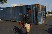 Police officer stands guard for security measures, followig the visit of the Iranian President Ebrahim Raisi, in Karachi